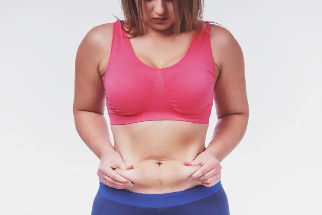 woman-poses-with-stomach-skin-pinch-2026-03-10-03-54-36-utc - Northvilla Beauty Spa